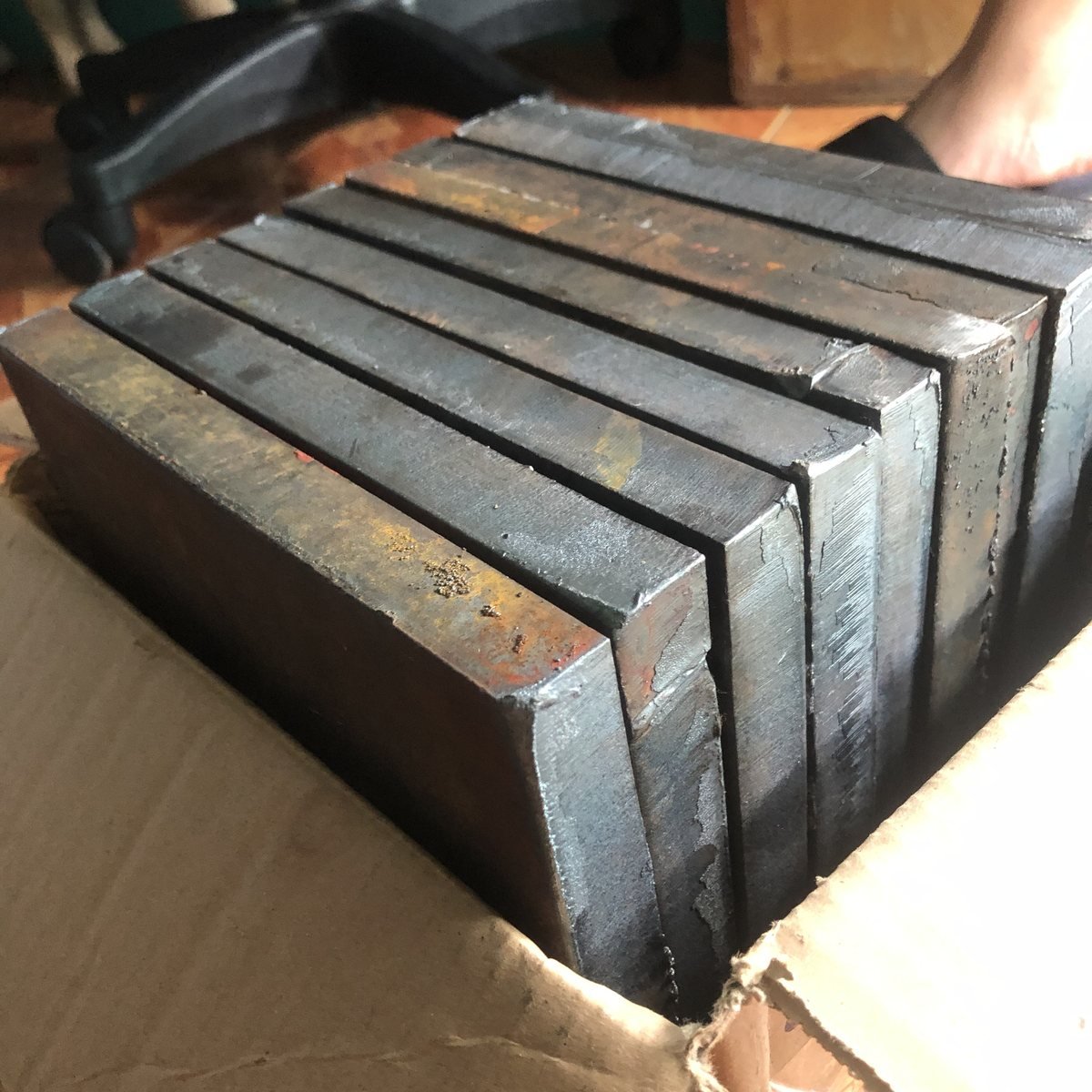Thick-section steel base plates packed for delivery — Southend