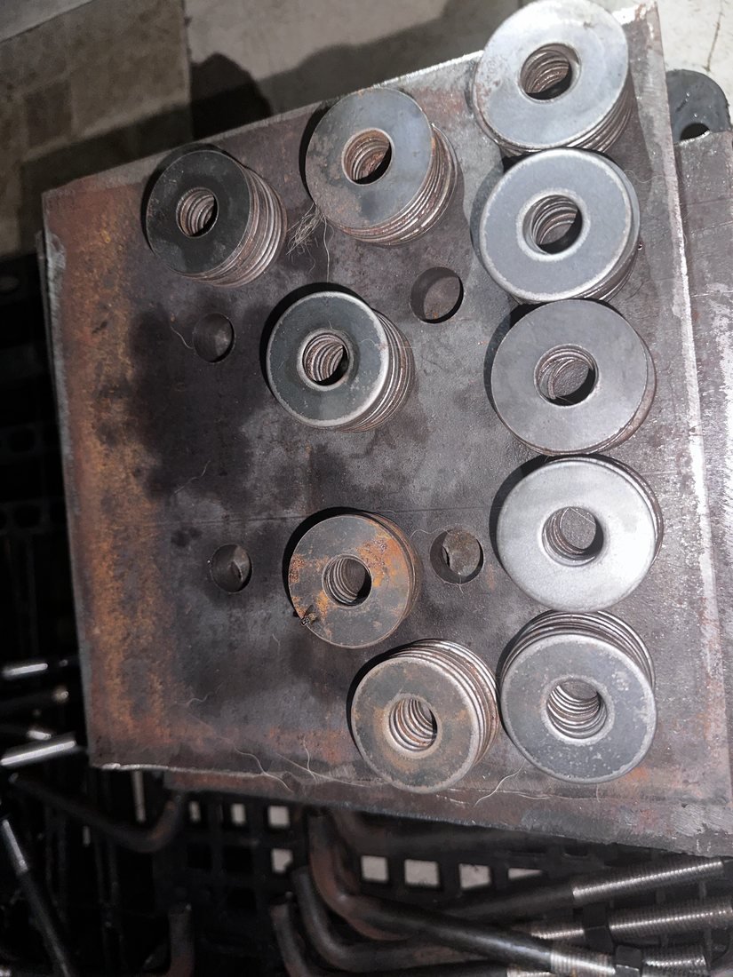 Anchor bolts and washers stacked on a drilled base plate — Southend